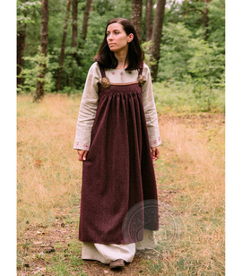 Wool apron dress with pleats from Kostrup, decorated with a woven trim